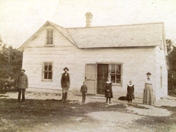 Petersons in front of house